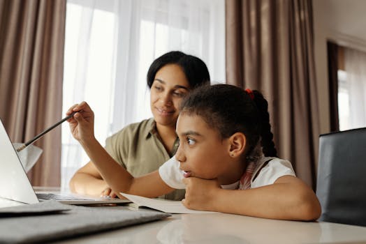 Advogada divórcio BELÉM Mother and daughter engaged in online learning at home, using a laptop.